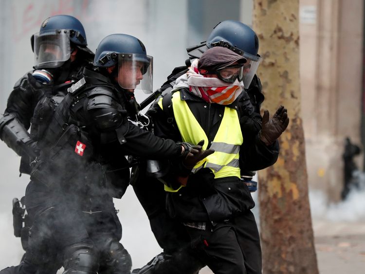French police detain a protester during clashes in Paris