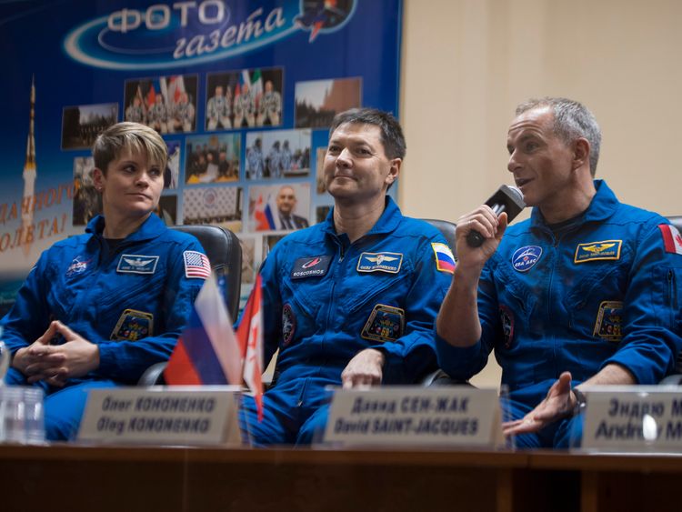Expedition 58 Flight Engineer David Saint Jacques answers a question during a press conference Sunday Dec. 2 2018 at the Cosmonaut Hotel in Baikonur Kazakhstan. He is seen with fellow crewmates Flight Engineer Anne Mc Clain of NASA left and Soyuz Com