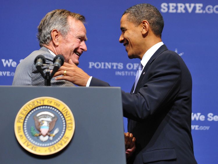 Former US president George H.W. Bush (L) greets President Barack Obama after introducing him on October 16, 2009 