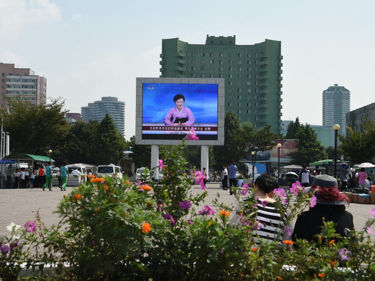 Ms Ri announces the news on a big screen in front of Pyongyang railway station
