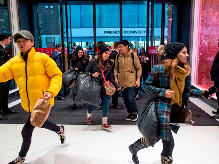 Shoppers run into the store as the doors of Selfridges open