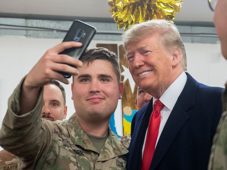 US President Donald Trump and First Lady Melania Trump arrive to speak to members of the US military during an unannounced trip to Al Asad Air Base in Iraq on December 26, 2018. - President Donald Trump arrived in Iraq on his first visit to US troops deployed in a war zone since his election two years ago (Photo by SAUL LOEB / AFP) (Photo credit should read SAUL LOEB/AFP/Getty Images)