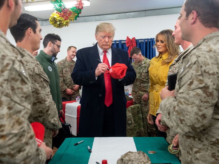 US President Donald Trump and First Lady Melania Trump arrive to speak to members of the US military during an unannounced trip to Al Asad Air Base in Iraq on December 26, 2018. - President Donald Trump arrived in Iraq on his first visit to US troops deployed in a war zone since his election two years ago (Photo by SAUL LOEB / AFP) (Photo credit should read SAUL LOEB/AFP/Getty Images)