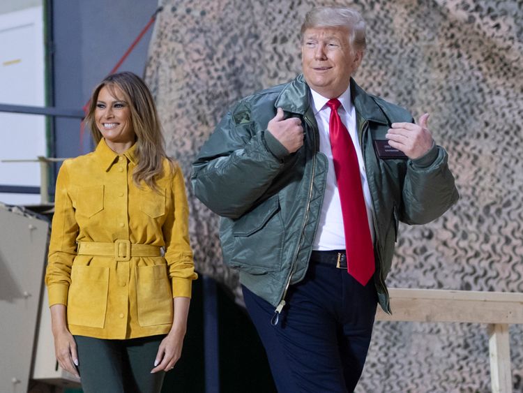 US President Donald Trump and First Lady Melania Trump arrive to speak to members of the US military during an unannounced trip to Al Asad Air Base in Iraq on December 26, 2018. - President Donald Trump arrived in Iraq on his first visit to US troops deployed in a war zone since his election two years ago (Photo by SAUL LOEB / AFP) (Photo credit should read SAUL LOEB/AFP/Getty Images)