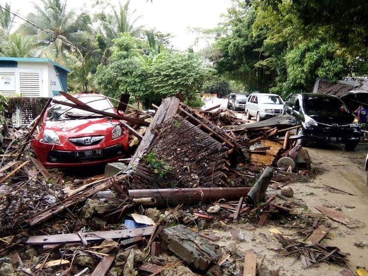 A damaged vehicle is seen amid wreckage from buildings along Carita beach on December 23, 2018, after the area was hit by a tsunami on December 22 following an eruption of the Anak Krakatoa volcano