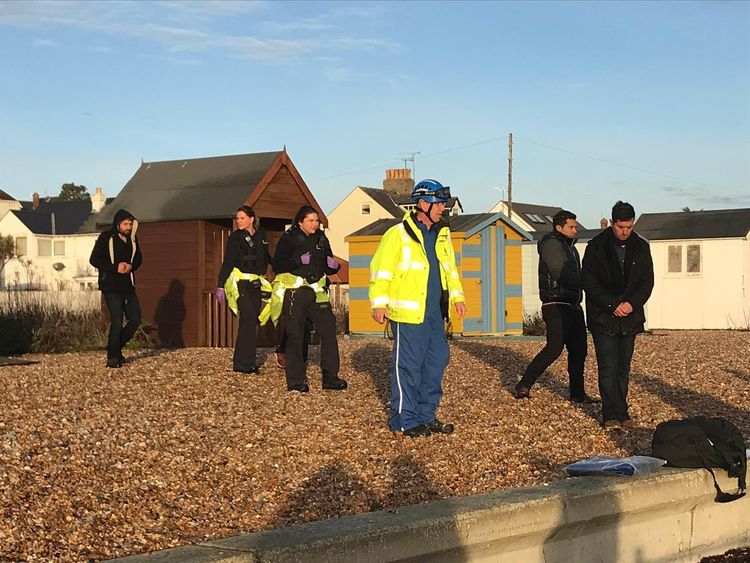 Border officials with suspected migrants on the beach at Kingsdown, Kent