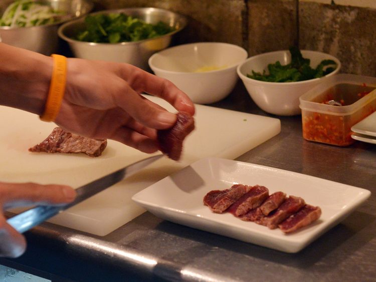 This picture taken on October 1, 2015 shows chef Eiichi Tsuchiya preparing whale meat carpaccio at his restaurant in Tokyo for the Ebisu whale meat festival