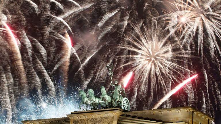 Fireworks explode over the Brandenburg Gate in Berlin