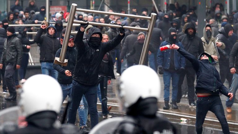 Far-right supporters throw barricades during a protest in Brussels