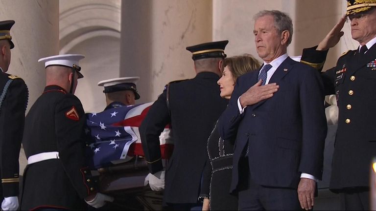 Bush watches fathers coffin pass into Capitol.