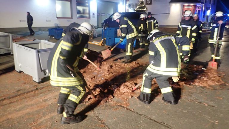 Spilt chocolate is cleared from a road in Werl, Germany 