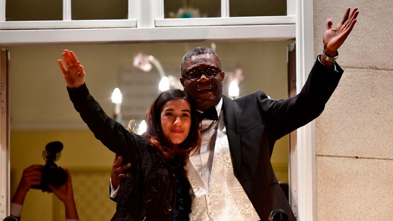Nobel prize laureates Congolese gynaecologist Denis Mukwege (R) and Iraqi Yazidi-Kurdish human rights activist Nadia Murad greet the crowd from the balcony of the Nobel suite in Oslo downtown, Norway on December 10, 2018