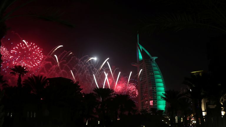 Fireworks explode over the Burj Al Arab hotel during the New Year celebrations in Dubai