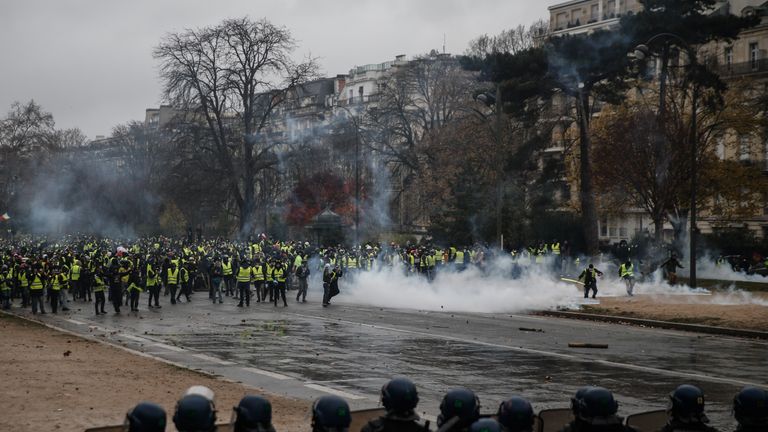 Protesters face riot police in Paris on 1 December