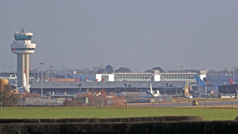 A police vehicle stands on the closed runway at Gatwick Airport after drones flying illegally over the airfield forced the closure of the airport
