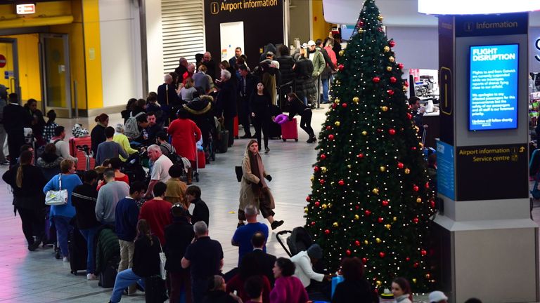 Passengers queue at Gatwick Airport