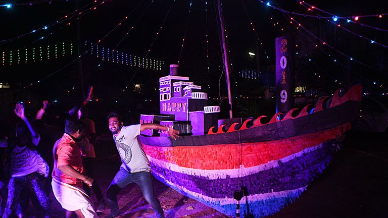 Indian youth welcome the New Year as they celebrate at a residential area in Chennai