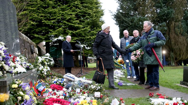 People pay their respects at the commemoration service in Lockerbie