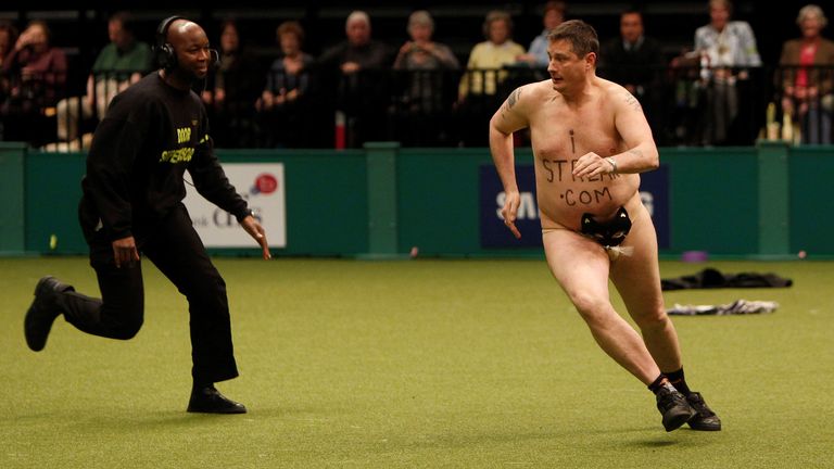 The streaker is chased by security at the Crufts dog show in 2010