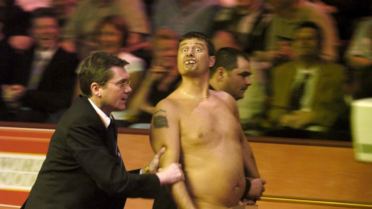 Mr Roberts is escorted away after streaking at the World Snooker Championships in 2004