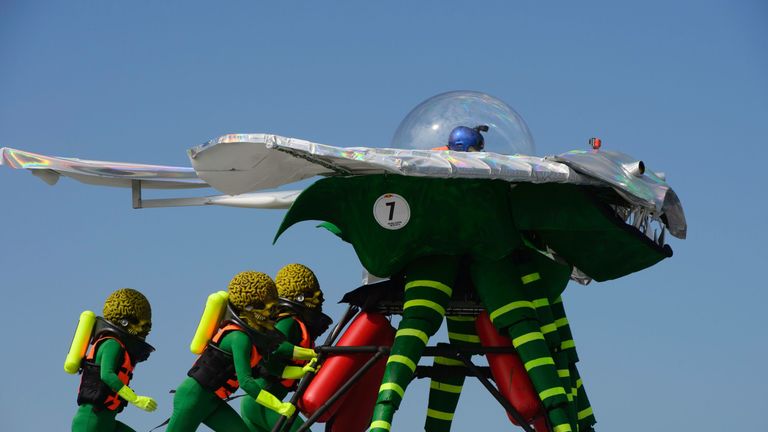 Participants dressed as alien characters from the film &#39;Mars Attacks!&#39; launch their flying contraption during the Red Bull Flugtag event in Hong Kong on November 27, 2016. The Flugtag -- which means &#39;flying day&#39; in German -- is a competition in which teams in fancy dress attempt to pilot human-powered, home-made flying machines off a platform into water. / AFP / TENGKU Bahar (Photo credit should read TENGKU BAHAR/AFP/Getty Images)