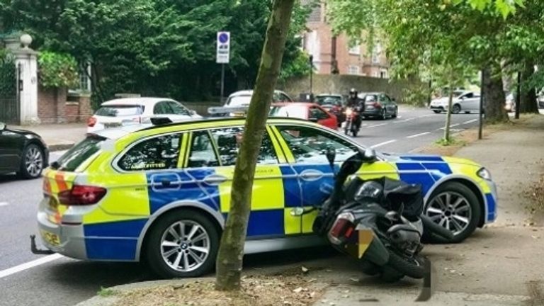 Moped stopped by police car