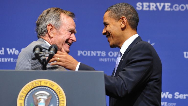 Former US president George H.W. Bush (L) greets President Barack Obama after introducing him on October 16, 2009 