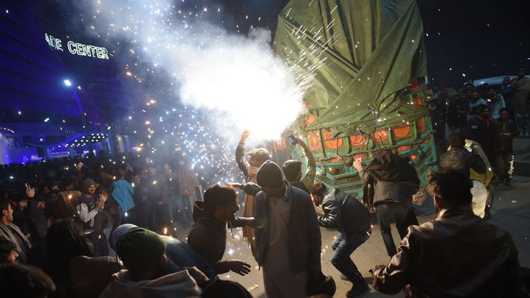 Pakistanis watch the fireworks display during the New Year celebrations in RawalpindI