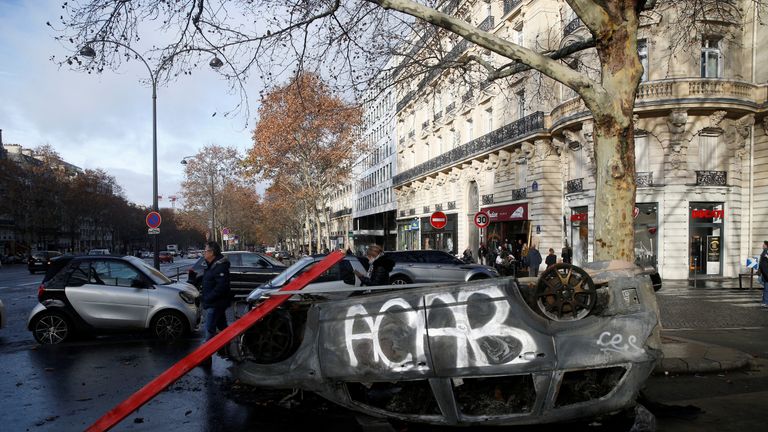A vandalised car is seen the morning after protests turned violent