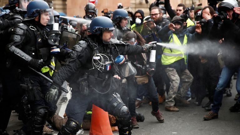 Police use pepper spray to push protesters back in Paris