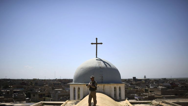 A Syriac Christian militiaman guards a church in the Iraqi town of Qaraqosh