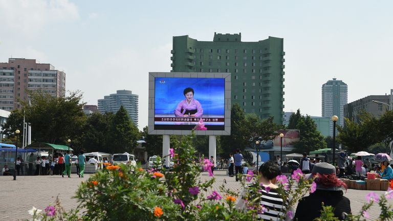 Ms Ri announces the news on a big screen in front of Pyongyang railway station
