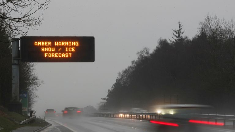 Cars travel past a weather warning sign on the A9 road near Stirling, in Scotland December 15, 2018