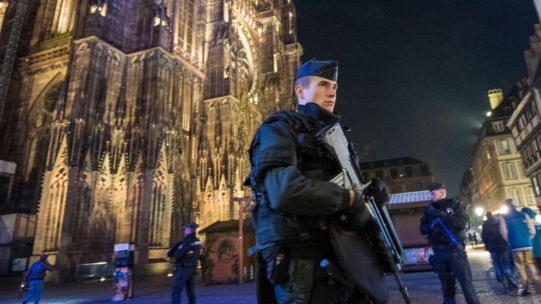 Police officers patrol in front of Strasbourg&#39;s cathedral