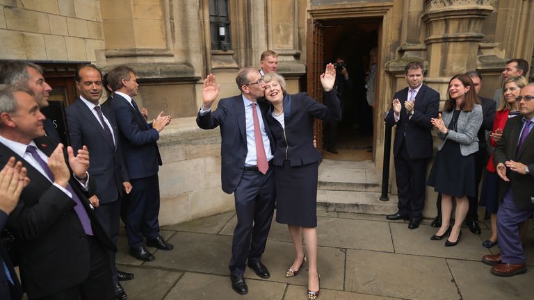 British Home Secretary Theresa May's husband Philip  kisses her head after her victory