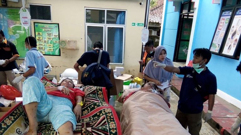 A survivor receives medical treatment at a hospital in Carita after the tsunami
