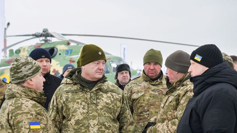 Mr Poroshenko (2nd L) and defence minister Stepan Poltorak (L) visiting an airbase over the weekend