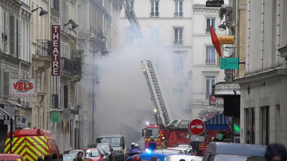 Fire fighters attend a blast at a bakery in central Paris