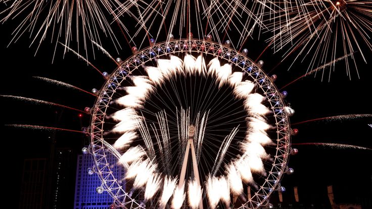 Fireworks explode over The London Eye and Elizabeth Tower near Parliament as thousands of revelers gather along the banks of the River Thames to ring in the New Year on January 1, 2019 in London, England