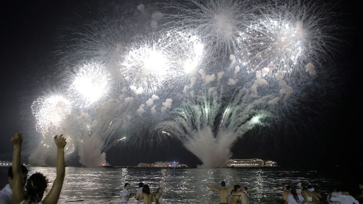 People watch as fireworks explode over Copacabana beach during New Year celebrations in Rio de Janeiro, Brazil January 1, 2019