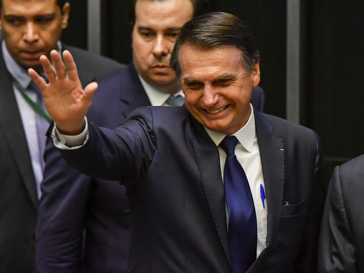 Jair Bolsonaro waves at Congress before he is sworn in as Brazil's new president