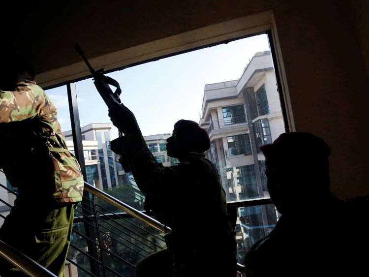 The Kenyan troops look for a building for the armed man