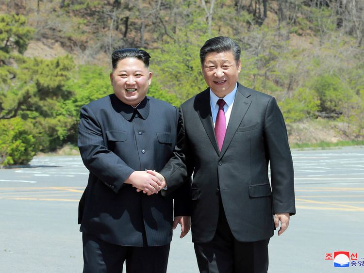 North Korean leader Kim Jong Un shakes hands with China's President Xi Jinping, in Dalian, China in this undated photo released on May 9, 2018
