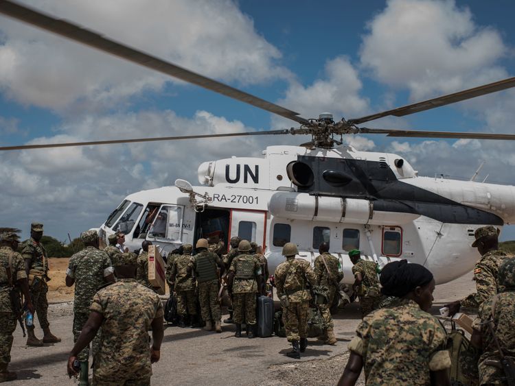Members of the 17th Battle Group of the Uganda People's Defense Force (UPDF) serving in the African Union Mission in Somalia (AMISOM) load an United Nations helicopter outside of AMISOM's Forward Operating Base Barawe on October 10, 2016