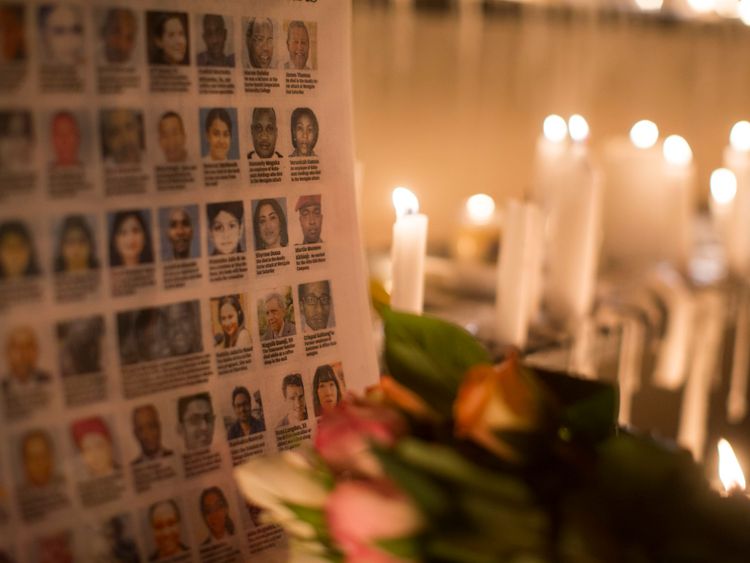  The photographs of the Westgate Shopping Centre victims are placed next to burning candles outside the Westgate Shopping Centre on September 28, 2013 in Nairobi, Kenya