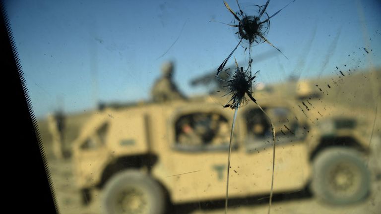 US Army soldiers seen through a cracked window of an armed vehicle in a checkpoint 