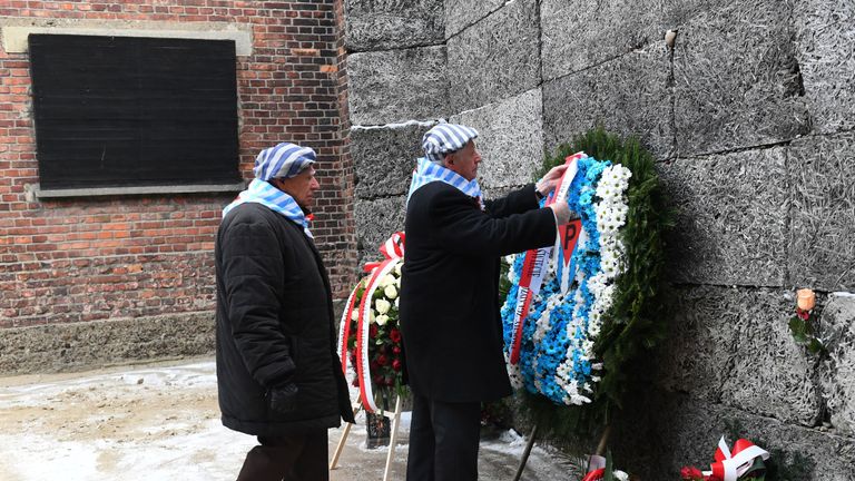 Former prisoners lay a wreath at the Death Wall marking the 74th anniversary of the liberation of Auschwitz