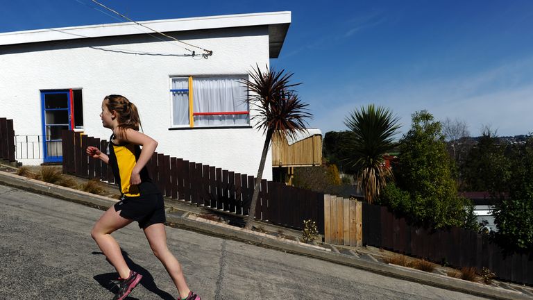 Competitors take part in a race up one of the world&#39;s steepest street in Dunedin, New Zealand on September 18, 2011
