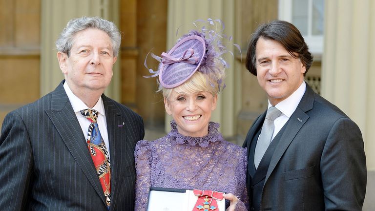 Barbara Windsor with husband Scott Mitchell (right) and agent Barry Burnett after being made a Dame Commander of the Order of the British Empire by Queen Elizabeth II at Buckingham Palace in 2016, for services to charity and entertainment