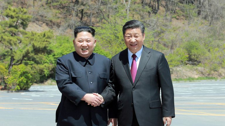 North Korean leader Kim Jong Un shakes hands with China's President Xi Jinping, in Dalian, China in this undated photo released on May 9, 2018